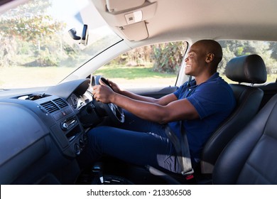 Happy Young African American Man Driving A Car