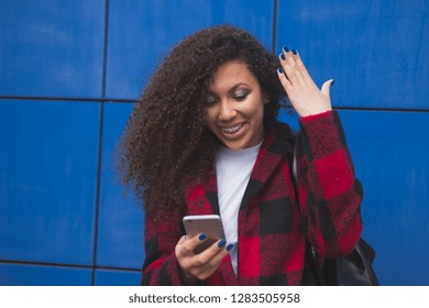 Happy Young African American Uni Student Using Cell Phone