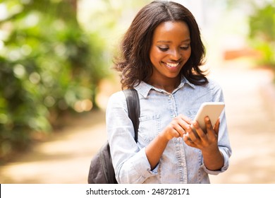 Happy Young African American Uni Student Using Cell Phone