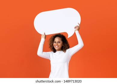 Happy Young African American Woman In Plain White Long Sleeve T-shirt Holding Empty Speech Bubble Isolated On Orange  Background