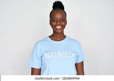 Happy young african american woman activist wears volunteer tshirt looks at camera isolated on grey background. Charity organization, volunteer help donation service, support, altruism concept.