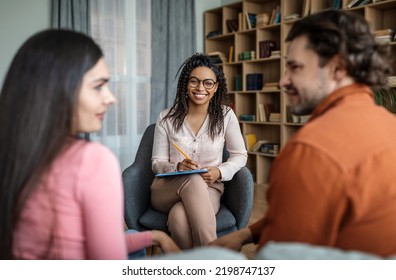 Happy Young African American Woman Psychologist Rejoices To Positive Result In Family Therapy In Office Clinic Interior. Couple Relationship, Love And Reconcile, Conflict Resolution And Psychology