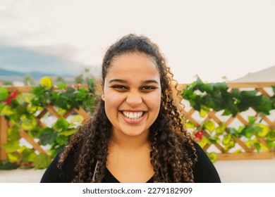Happy young African girl having fun smiling in front of camera on house patio - Shutterstock ID 2279182909
