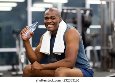 Happy Young African Man Drinking Water After Exercise