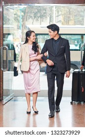 Happy Young Asian Business Couple Entering Hotel Lobby