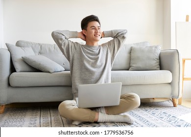 Happy Young Asian Business Man Staying At Home Sitting On Carpet Working Using Laptop Computer Happy And Smiling