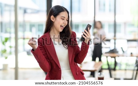 Happy Young Asian Business Woman Successful Excited Raised Hands Rejoicing With Smartphone.