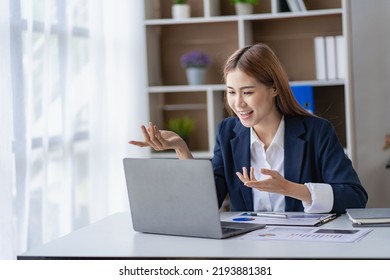 Happy Young Asian Businesswoman In A Successful Business Excitedly Raising Her Hand With A Laptop Computer In The Office. New Start Project Idea