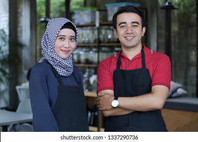 Happy Young Asian Couple Cafe Owner In Front Of Coffee Shop Smiling. Portait Of Two Waiters At Restaurant