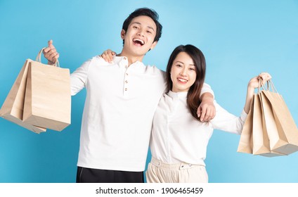 Happy Young Asian Couple Happily Going Shopping