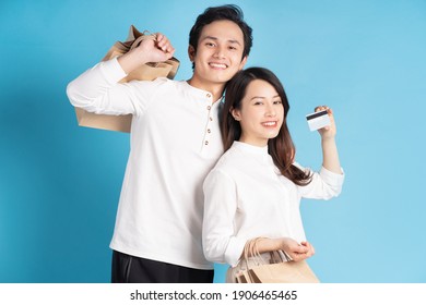 Happy Young Asian Couple Happily Going Shopping