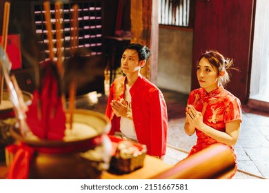 Happy Young Asian Couple Love In Chinese Traditional Dresses Praying At Chinese Temple