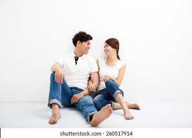 Happy Young Asian Couple Sitting On Floor 