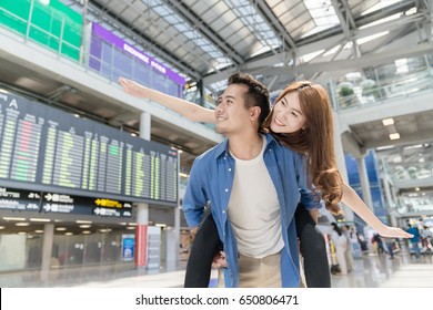 Happy Young Asian Couples Traveler Having Fun At Airport Terminal. Travel And Lover Concept