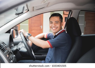 Happy Young Asian Driver Smiling To Camera