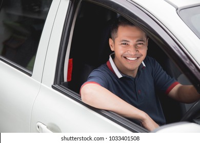 Happy Young Asian Driver Smiling To Camera