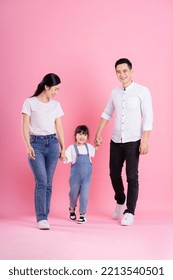 happy young asian family image, isolated on pink background