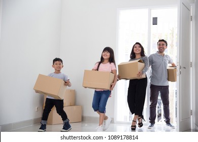 Happy Young Asian Family Moving To A New House