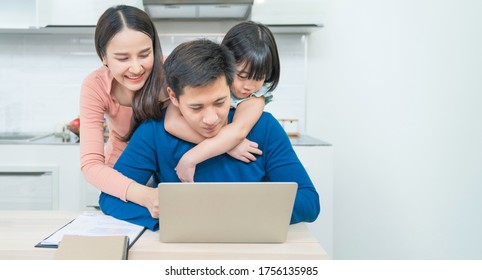 Happy Young Asian Girl With Her Lovely Parents Using Laptop Computer For Education And Spent Quality Time Together. Asian Family. Social Distancing. Homeschooling. Work From Home Or Love Concept