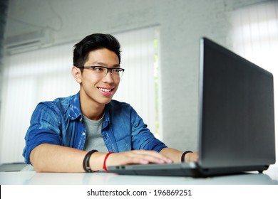 Happy Young Asian Man Working At Office