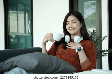 Happy young Asian saleswoman looking at camera welcoming client. Smiling woman executive manager, secretary offering professional business services holding digital tablet standing in office. Portrait - Powered by Shutterstock