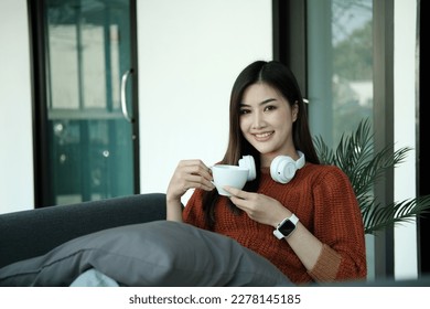 Happy young Asian saleswoman looking at camera welcoming client. Smiling woman executive manager, secretary offering professional business services holding digital tablet standing in office. Portrait - Powered by Shutterstock