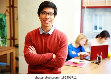 Happy Young Asian Student In Classroom