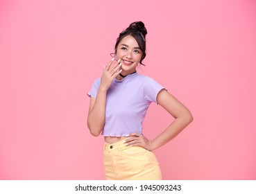 Happy Young Asian Teenage Girl On Pink Background. 