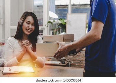 Happy Young Asian Woman Customer Smiling Receive Parcel Post Box From Home Delivery Service Man In Blue Uniform At Home, Express Home Delivery Service, Transport Logistics And Online Shopping Concept