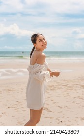 Happy Young Asian Woman In Dress Enjoying On The Beach In Summer Vacation