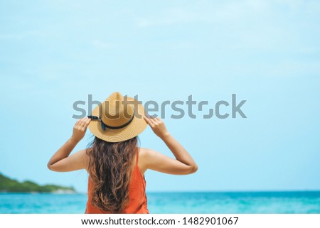 Happy young asian woman enjoy summer vacation on the tropical beach.