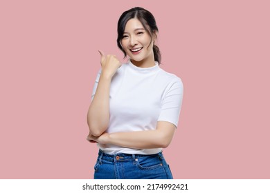 Happy young Asian woman feeling happiness and gesture thumb up on isolated pink background with copy space. - Powered by Shutterstock