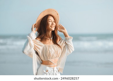 Happy young asian woman with freedom on the sea beach at golden sunset, Female tourist on seaside summer vacation - Powered by Shutterstock