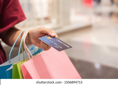 Happy Young Asian Woman Holding Credit Card And Colorful Shopping Bags, Woman Lifestyle Concept	