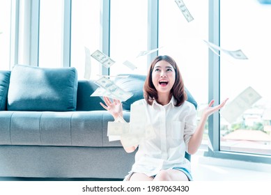 Happy Young Asian Woman Holding Dollar Money And Throw In The Air Celebrate Happiness Dance Wealth Lottery Money Rain Drop. Winner Success Business Woman Throw Cash Flow Happy Money Smiling Face