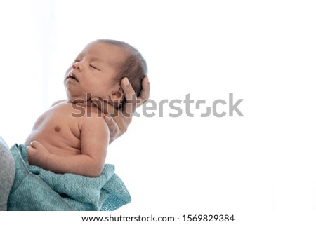 Similar – Newborn lying on bed embraced by her mother