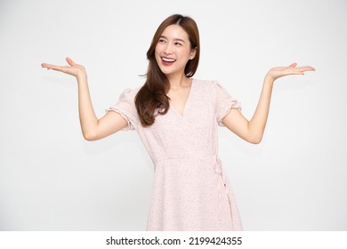 Happy young Asian woman presenting or showing open hand palm with copy space for product isolated on white background - Powered by Shutterstock