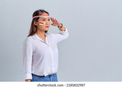 Happy young Asian woman salute gesture with copy space isolated on white background. Indonesian independence day concept