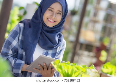 Happy Young Asian Woman With Tablet In The Farm. Modern Urban Farming Concept