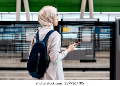 Happy young Asian woman at the train station. Enjoying travel concept - Powered by Shutterstock