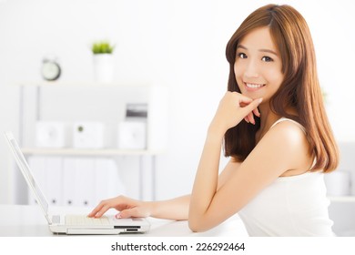 Happy Young Asian Woman Using A Laptop