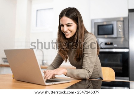 happy young attractive woman shopping online with a laptop computer using a credit card. e-commerce, business concept