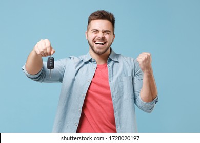 Happy Young Bearded Guy 20s In Casual Shirt Posing Isolated On Pastel Blue Wall Background Studio Portrait. People Emotions Lifestyle Concept. Mock Up Copy Space. Hold Car Keys, Doing Winner Gesture