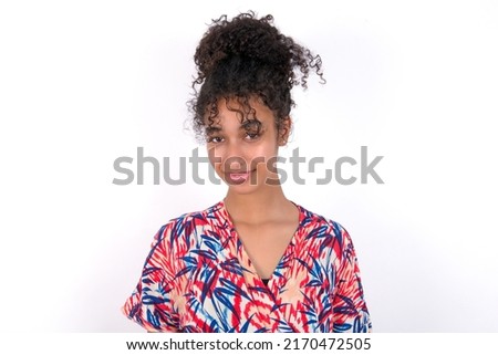Happy young beautiful brunette woman wearing colourful dress over white wall looking at camera with charming cute smile.