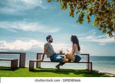 Happy Young Beautiful Couple In Love At Tropical Resort Enjoying Vacation Drinking Cocktails On Beach With Sea View