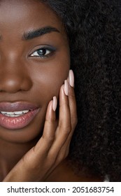 Happy young black African woman model with curly afro hair touching flawless radiant smooth face skin care on background. Ethnic natural beauty skincare, nails manicure ads. Closeup vertical portrait