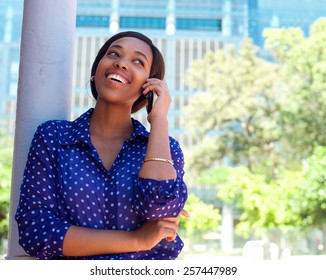 Happy Young Black Woman Calling By Mobile Phone Outdoors