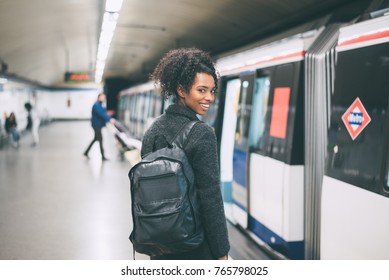 Happy Young Black Woman Inside The Underground Station Waiting For The Train