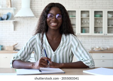 Happy Young Black Woman Student Looking At Web Camera Having Video Call Virtual Meeting Working Or Remote Learning At Home Talking By Videocall Conference. Webcam View Portrait. Distance Education