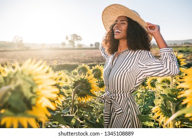 Happy Young Black Woman In A Sunflower Field